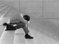 Depressed Businessman Sitting on Stairs